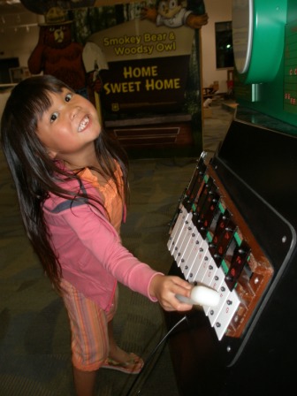 Kasen playing the keyboard at the Discovery Center